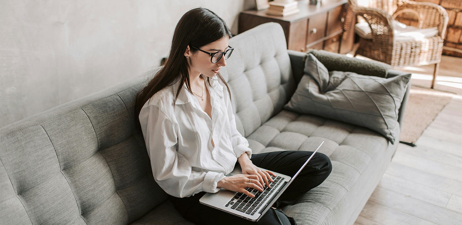 Girl working on a laptop on her couch