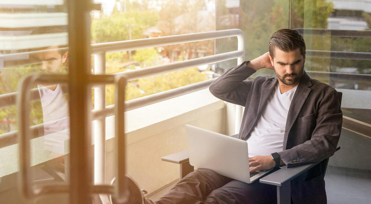 Man loounging while working